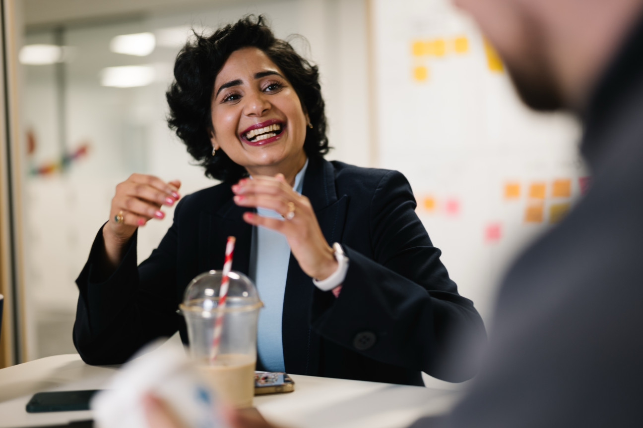 Colleague in suit smiling in meeting