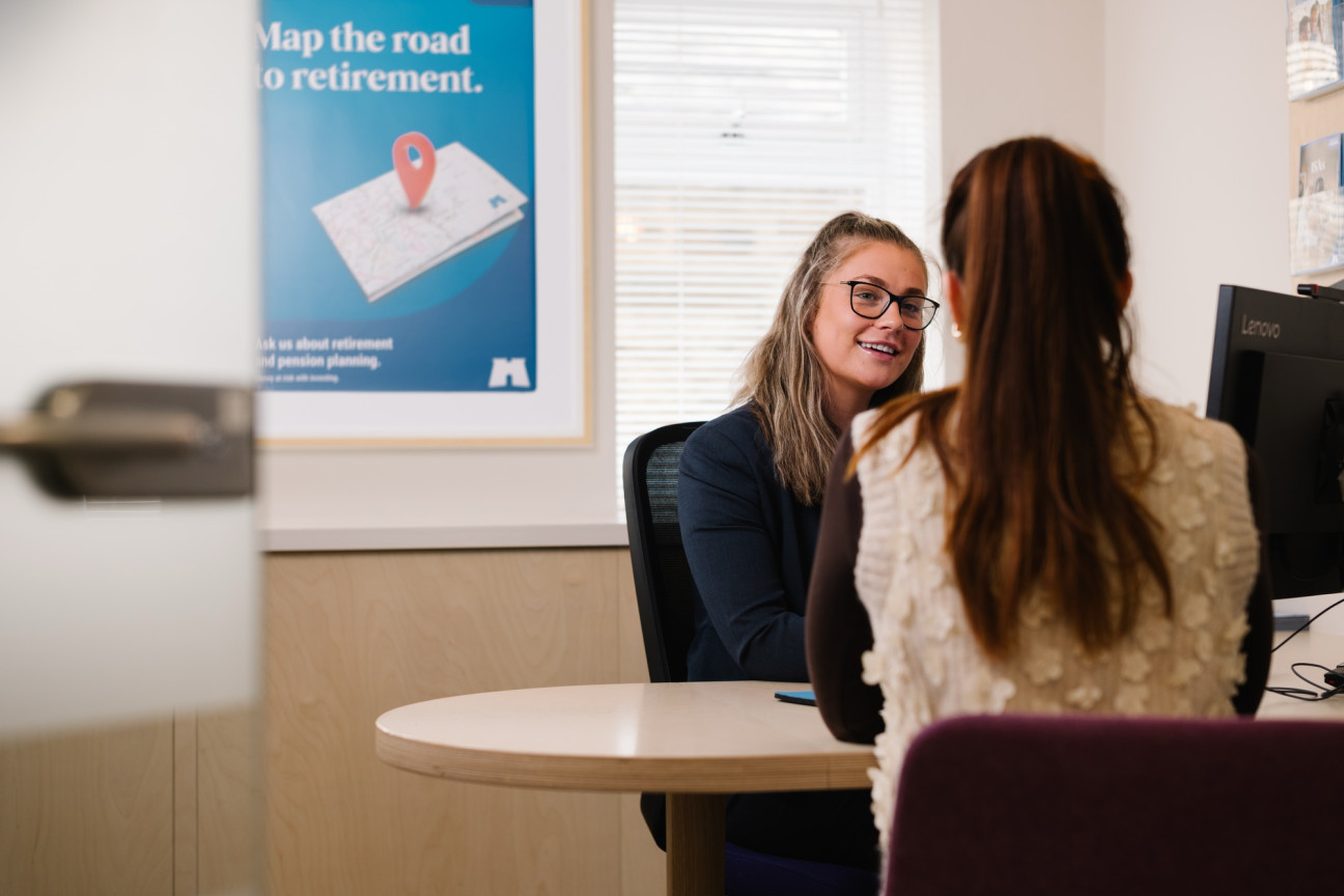 Branch colleague chatting to customer at desk