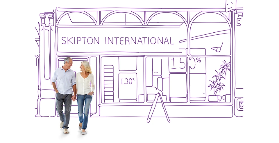 Couple standing outside Skipton International branch.