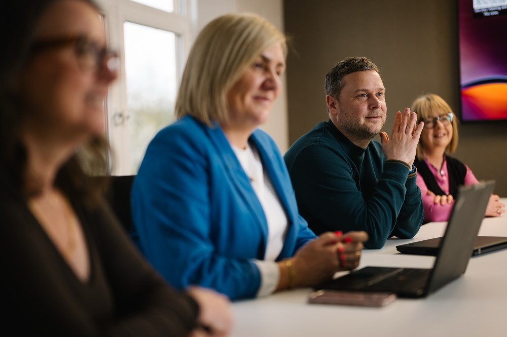 Colleagues in team meeting at Skipton Head Office.