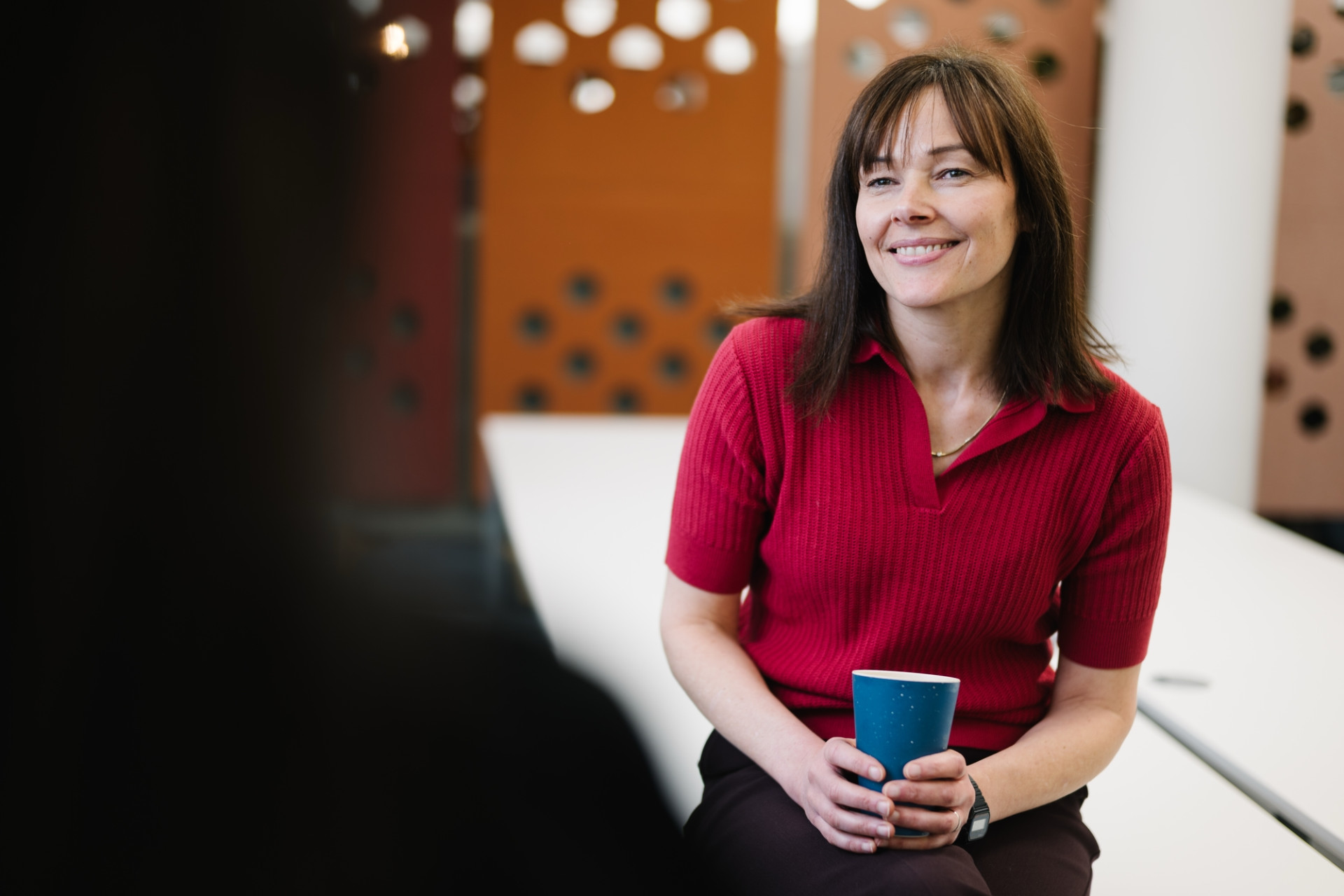Skipton colleague sat in head office with coffee.