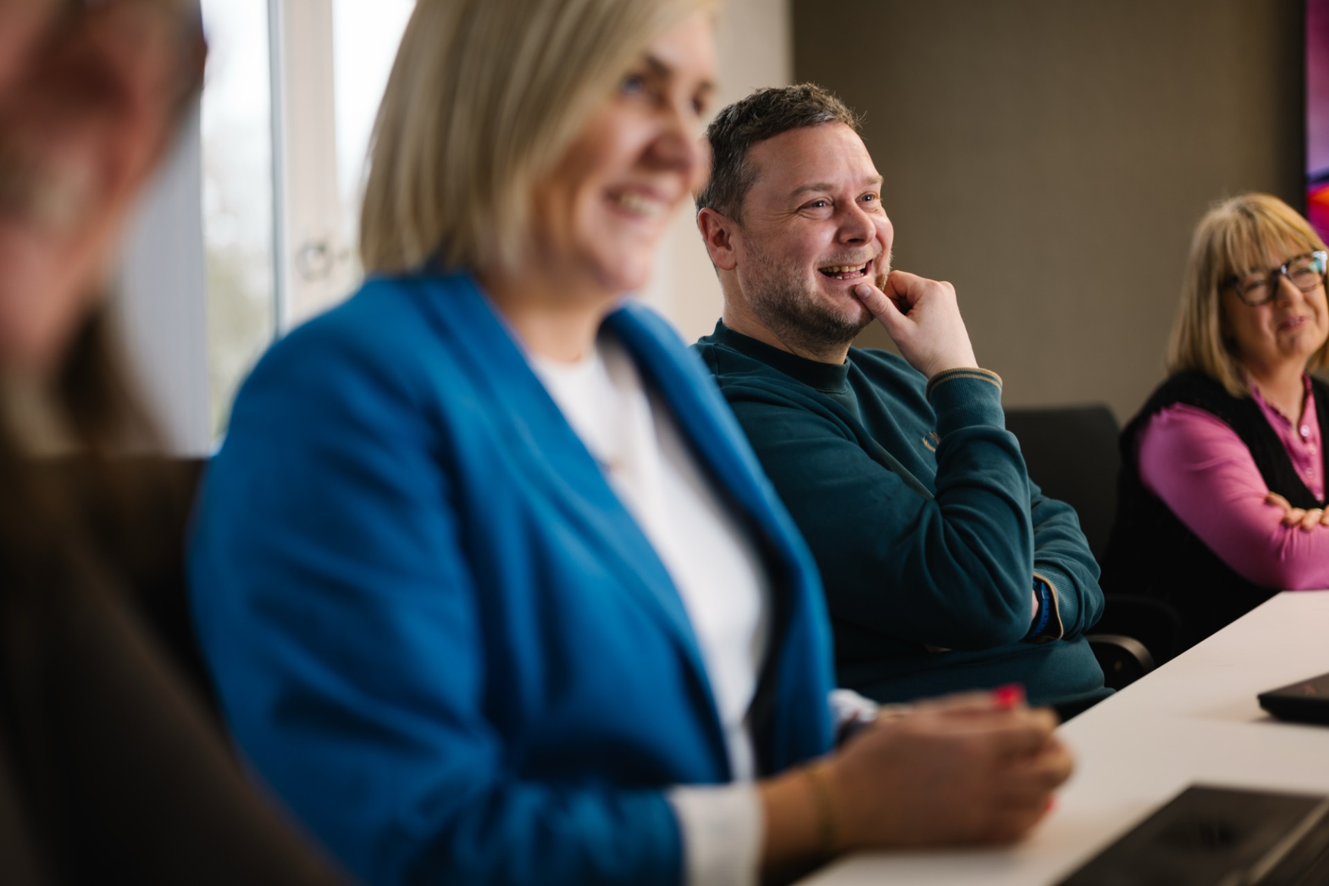 Colleague smiling in team meeting