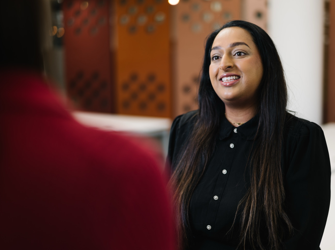 Alia chatting to colleague at Skipton Head Office.