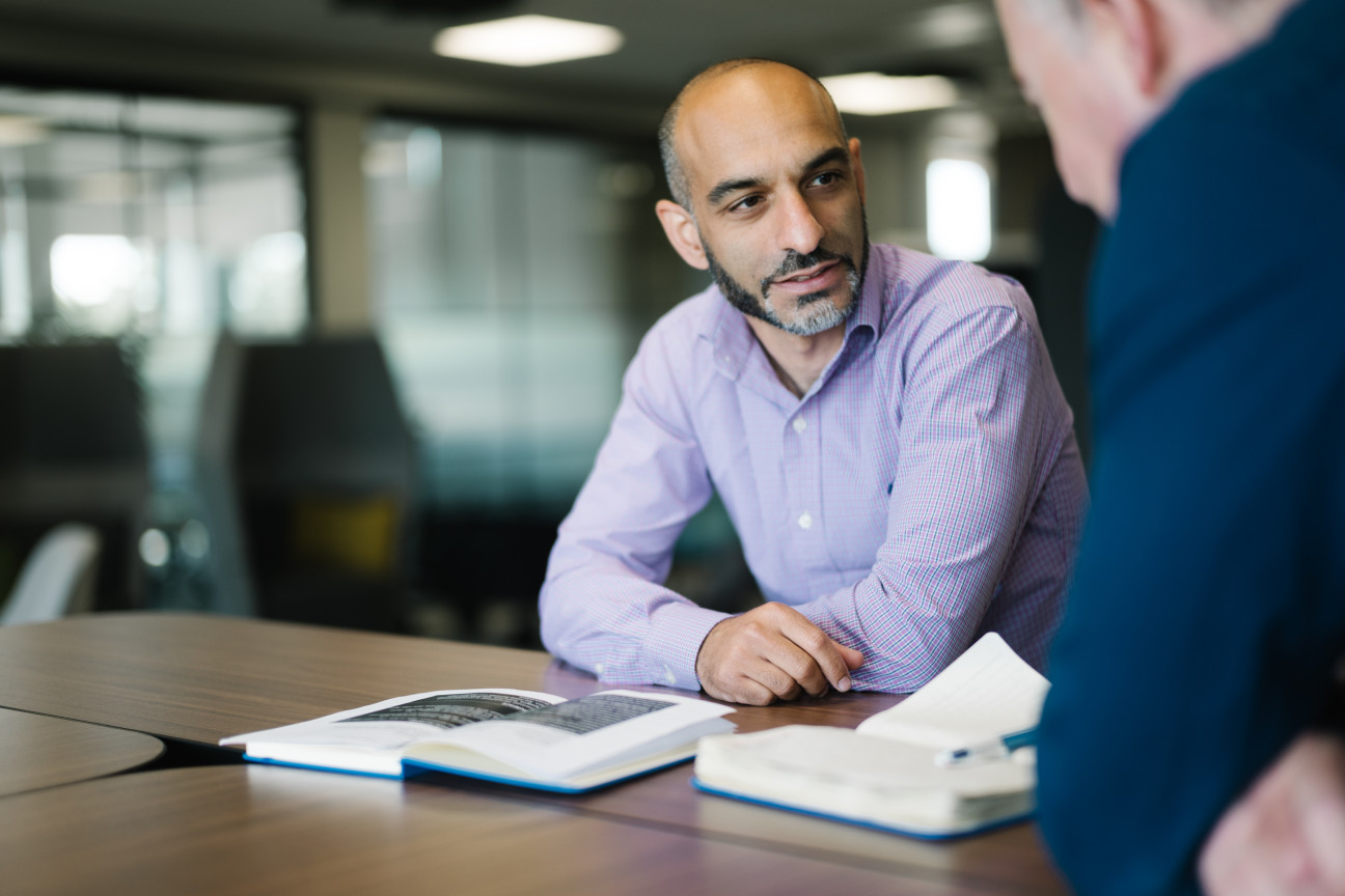 Maitham chatting to colleague in Skipton's The Bailey Head Office
